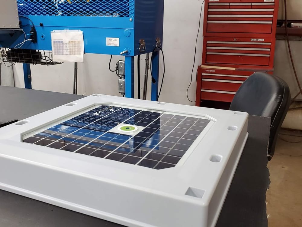 A Tessera HAIL sensor on the test bench at Koontz Labs, its solar panel and green Hailios eye facing up